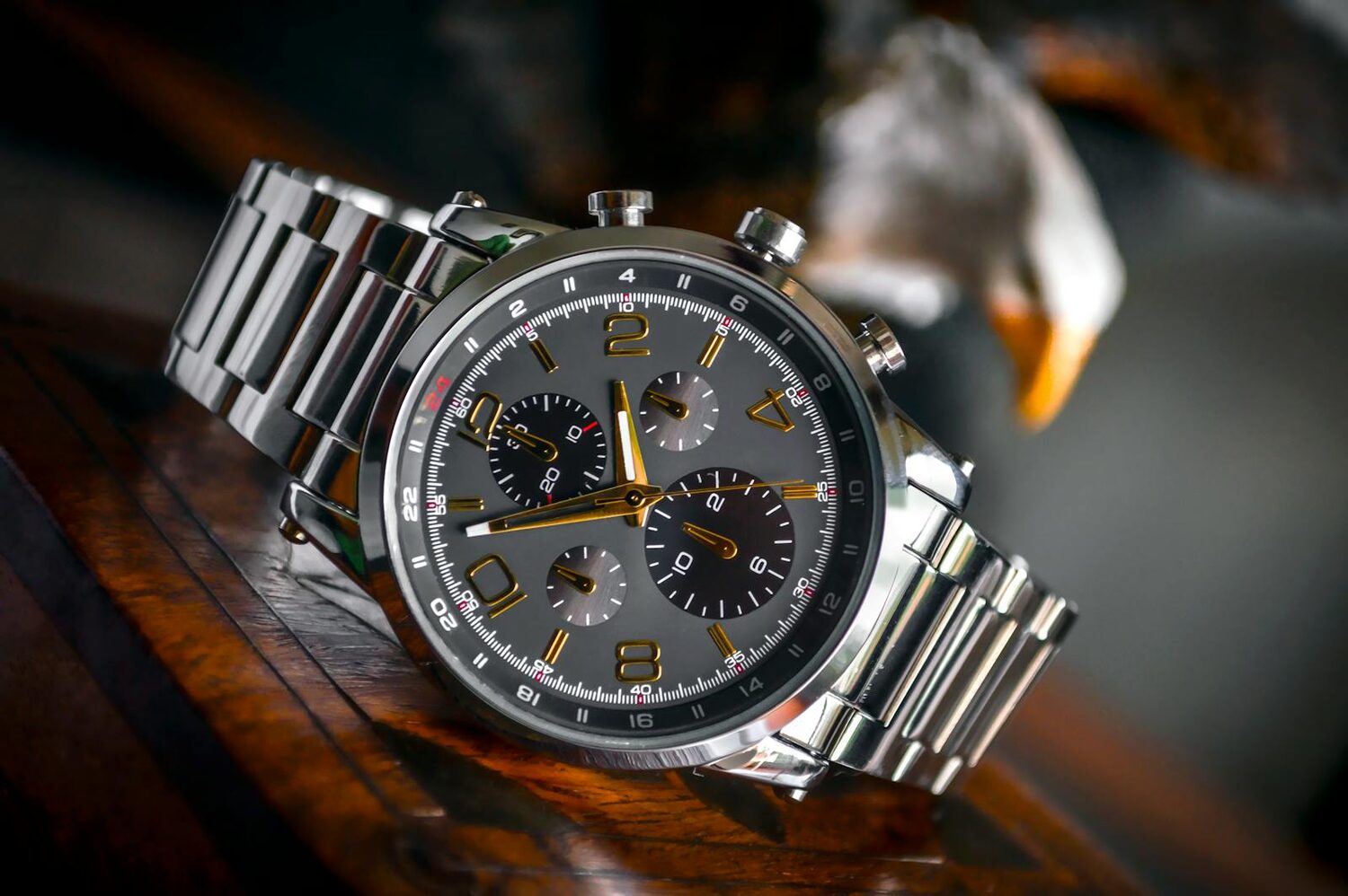 A luxury chronograph wristwatch resting on a wooden surface